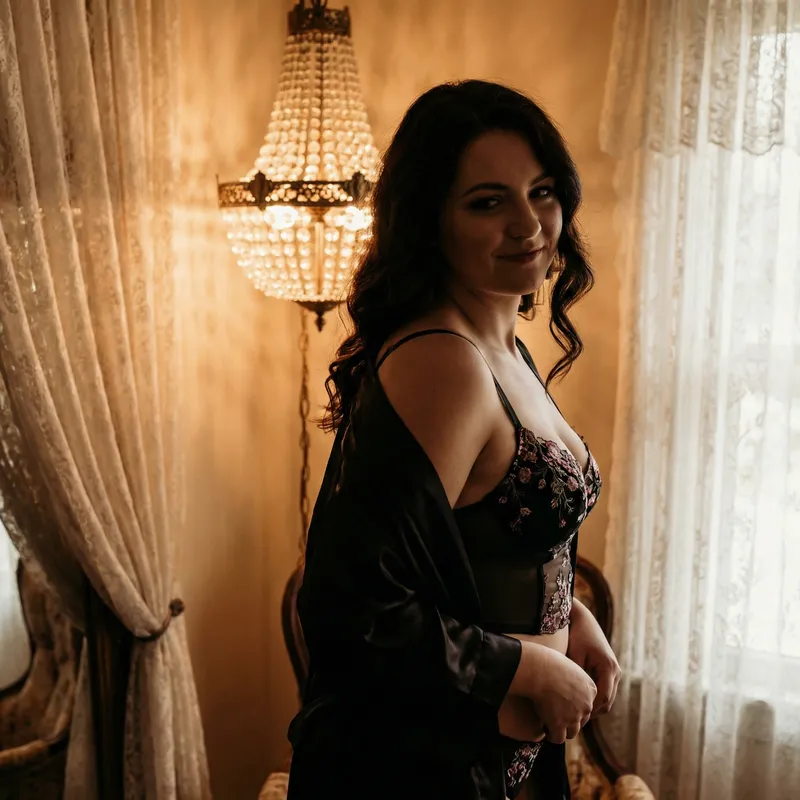 Sheer bodystocking layered under a black satin robe